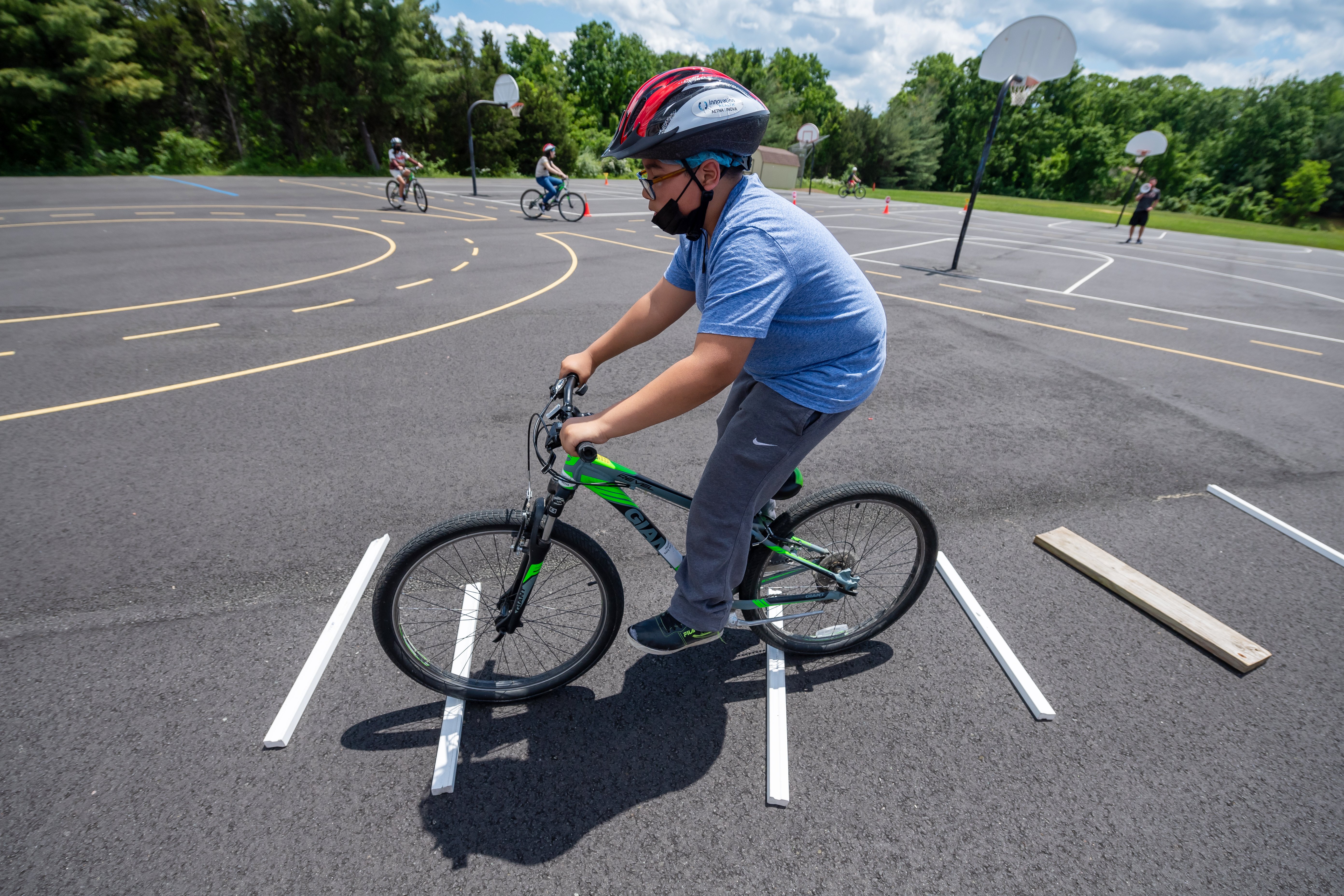 Students practice going over obstacles during their bike safety unit at Poe Middle School.