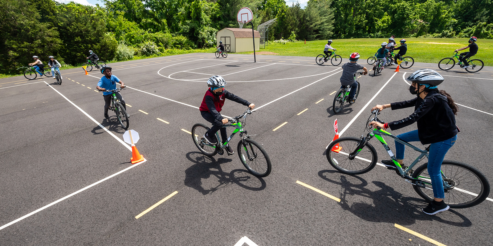 Students navigate a mock intersection during their bike safety unit at Poe Middle School.
