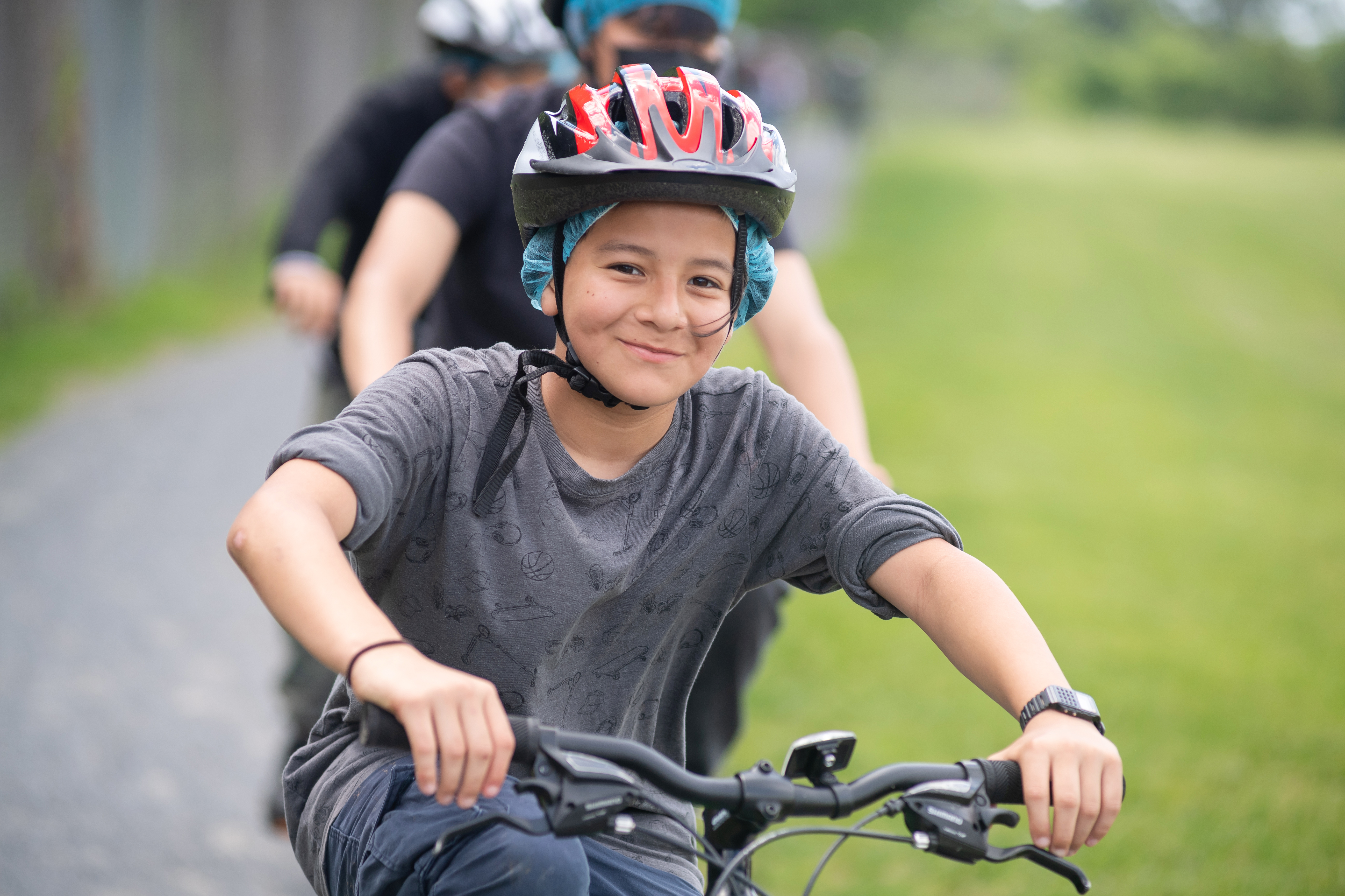 A Poe MS student smiles while riding a bike in physical education class.